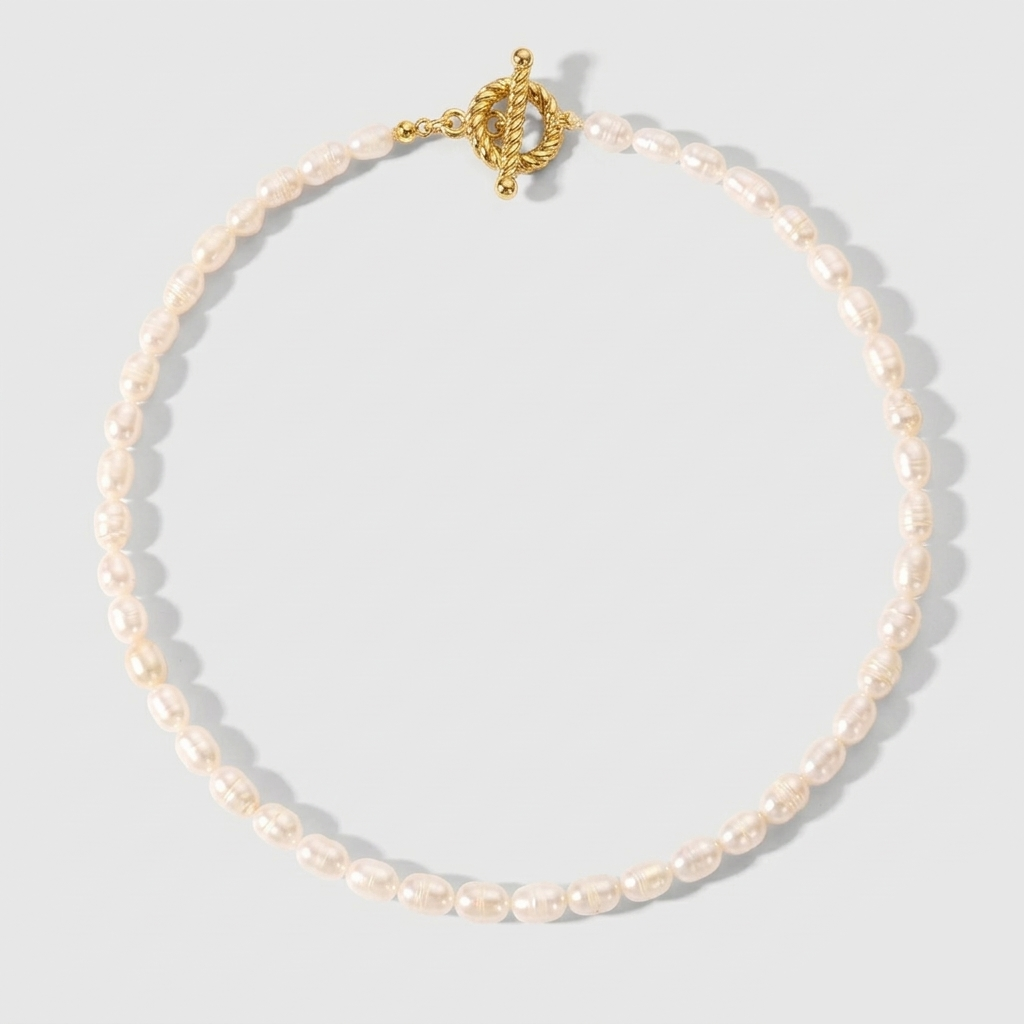 A multi-strand choker necklace featuring five rows of delicate white seed pearls and a central 18ct gold plated medical steel floral motif with an iridescent stone centre.