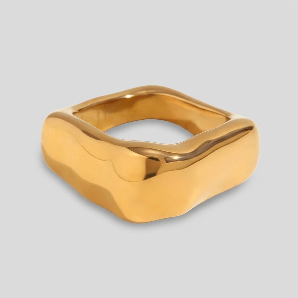 A wide, chunky dome ring in 18ct gold plated medical steel featuring a vertical ridged (fluted) texture on a high-shine polished surface.
