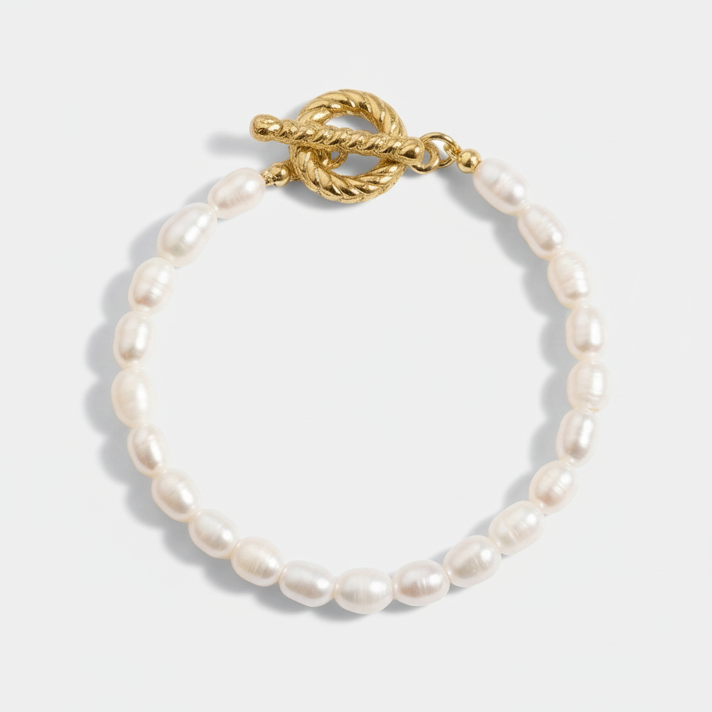 A single-strand freshwater pearl bracelet with white potato-shaped pearls and a decorative 18ct gold plated medical steel toggle (T-bar) clasp.