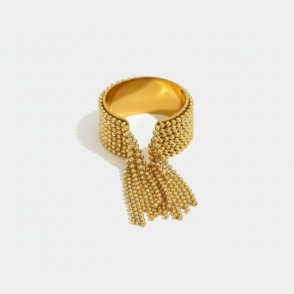 A wide 18ct gold plated medical steel statement ring featuring a cascading fringe of polished gold-tone ball chains that create movement.