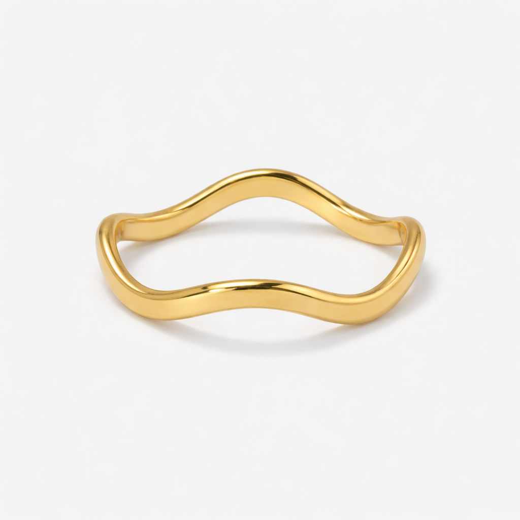 A minimalist wavy stacking ring made from 18ct gold plated medical-grade stainless steel. Features a high-shine polished finish and a fluid, organic curved shape.