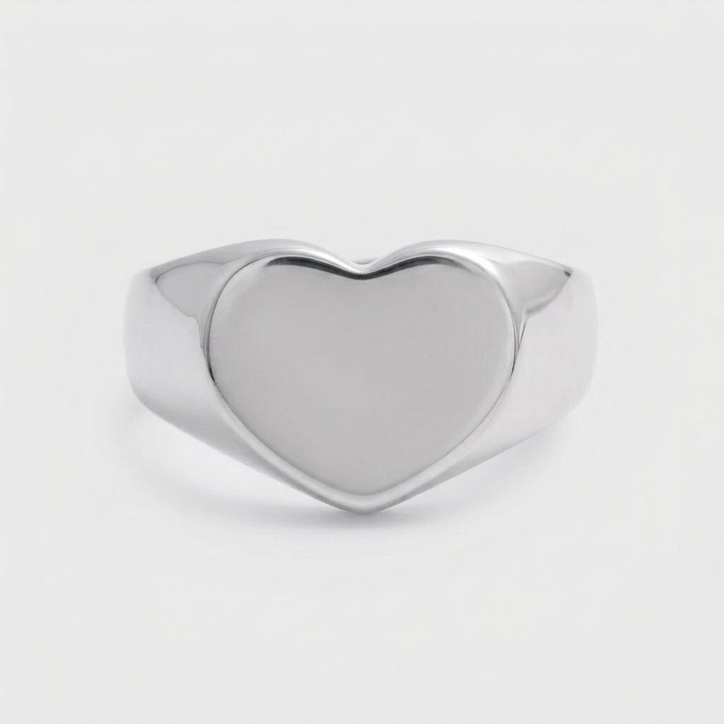 A chunky 18ct gold plated medical steel signet ring featuring a large, polished heart-shaped face. High-shine finish, hypoallergenic and tarnish-resistant.