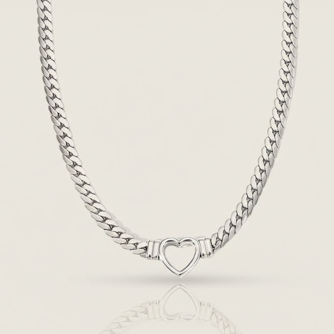 Silver chain necklace with a heart-shaped clasp on a white background
