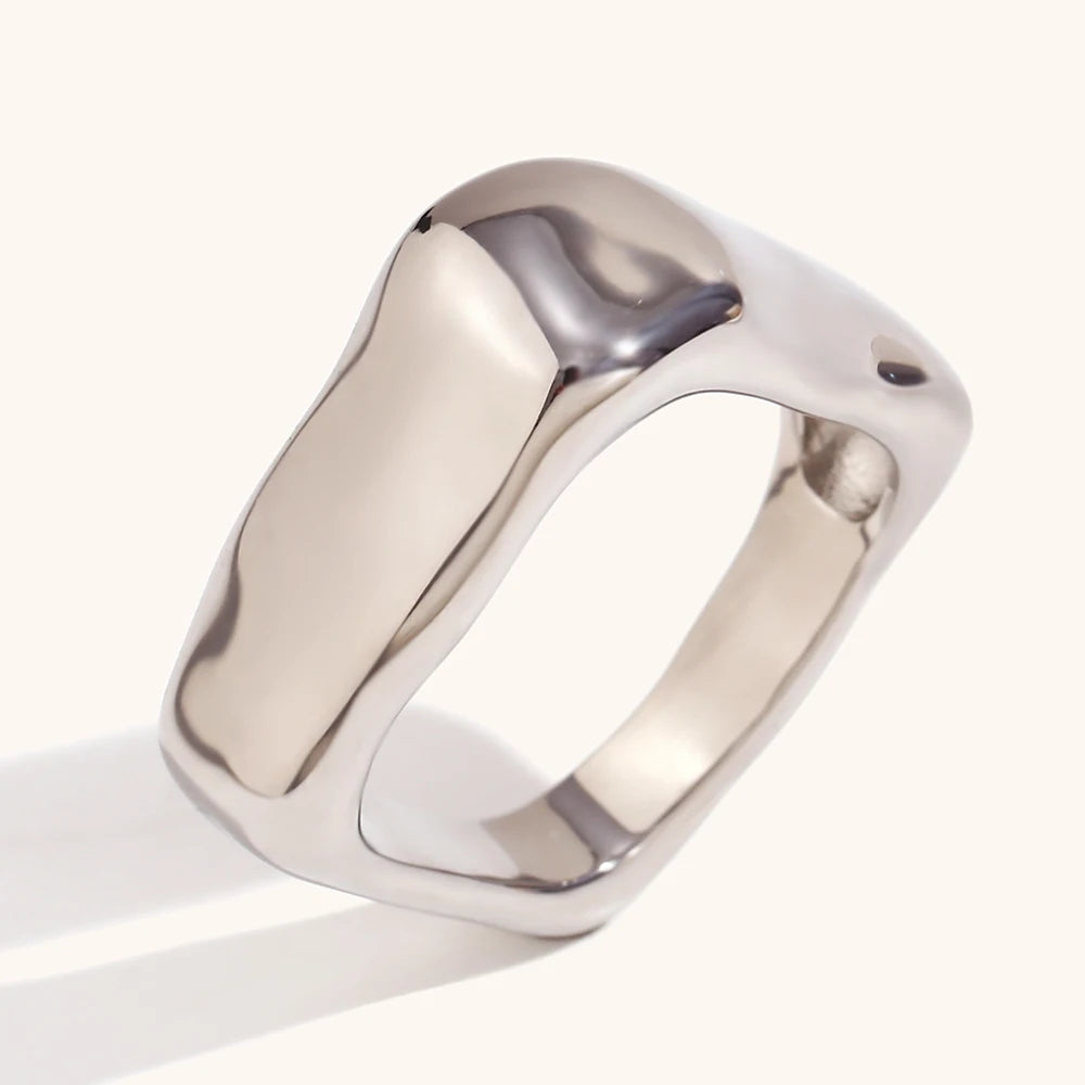 A wide, chunky dome ring in 18ct gold plated medical steel featuring a vertical ridged (fluted) texture on a high-shine polished surface.