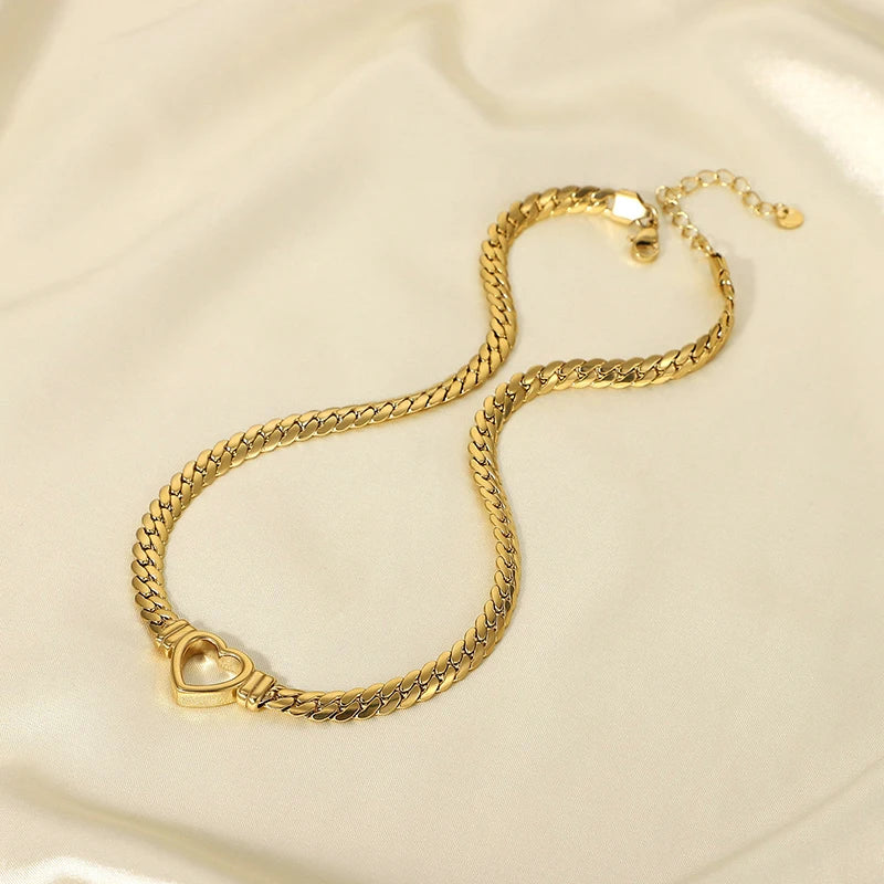 Gold chain bracelet on a light beige background