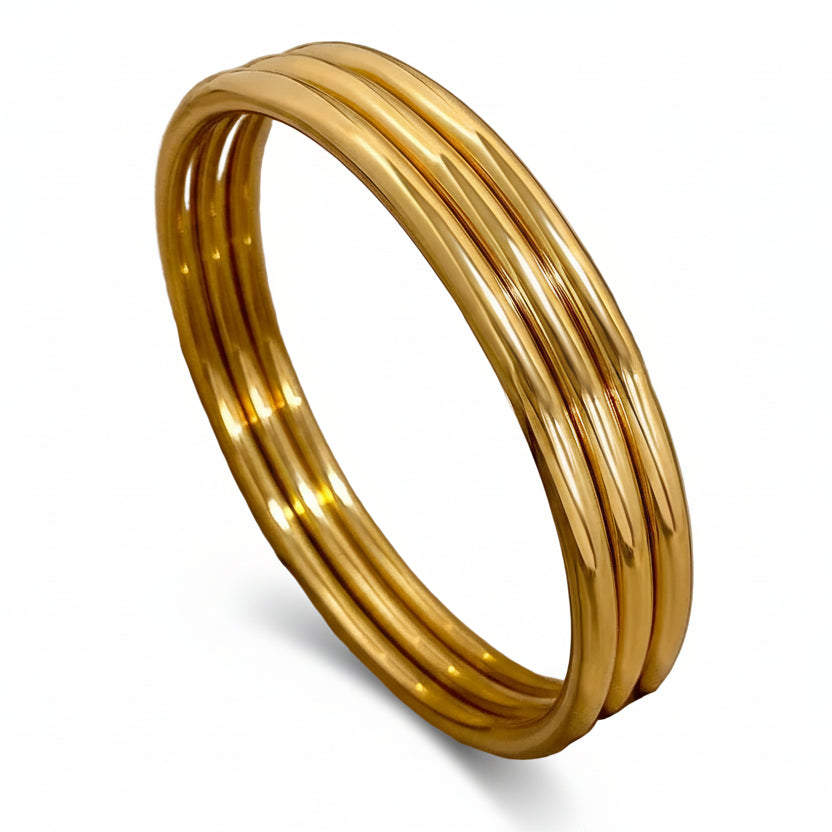 Gold bracelet on a beige fabric background