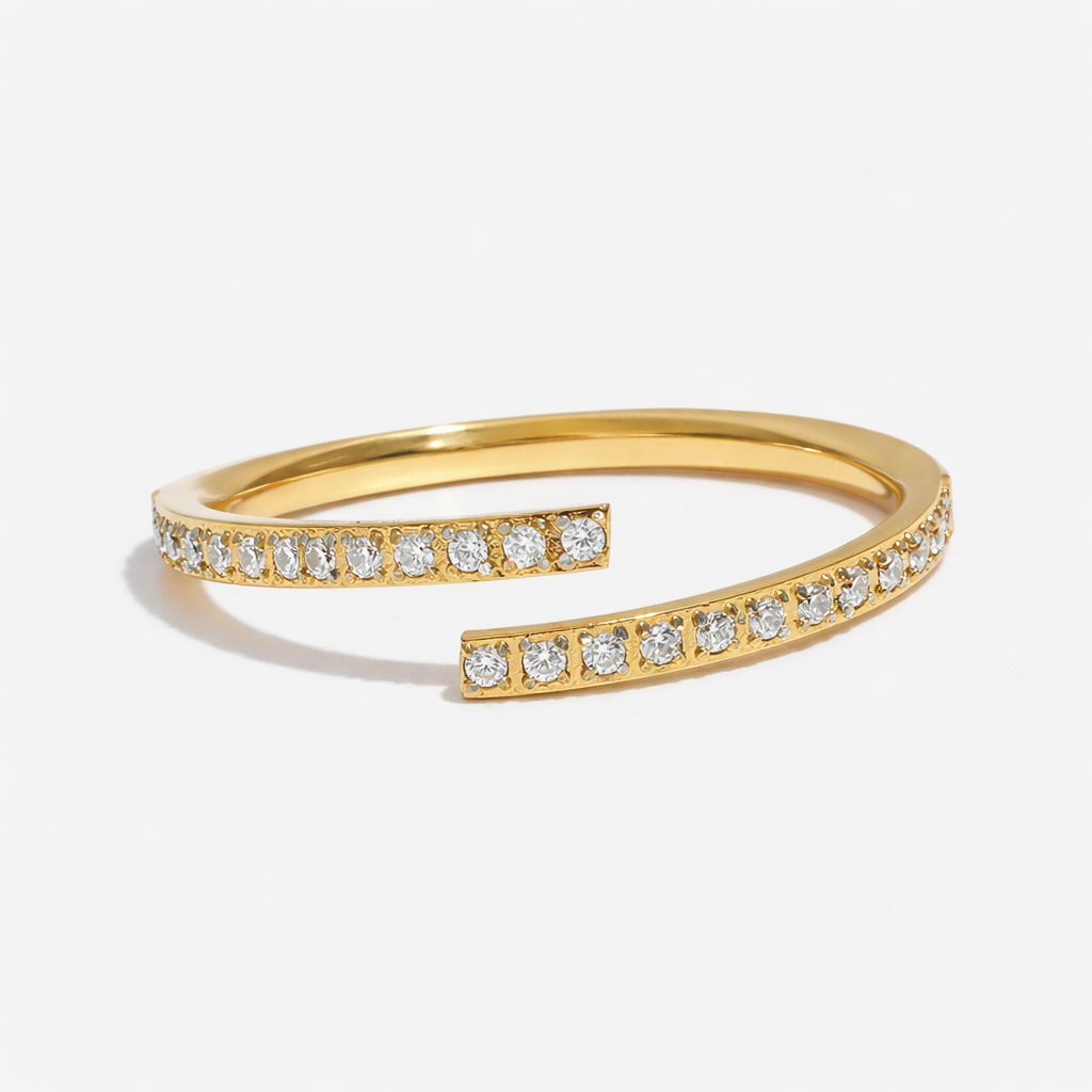 Elegant slim wrap ring crafted from tarnish-proof 18k gold plated stainless steel, featuring sparkling pavé-set crystals. Perfect for a minimalist jewellery stack.