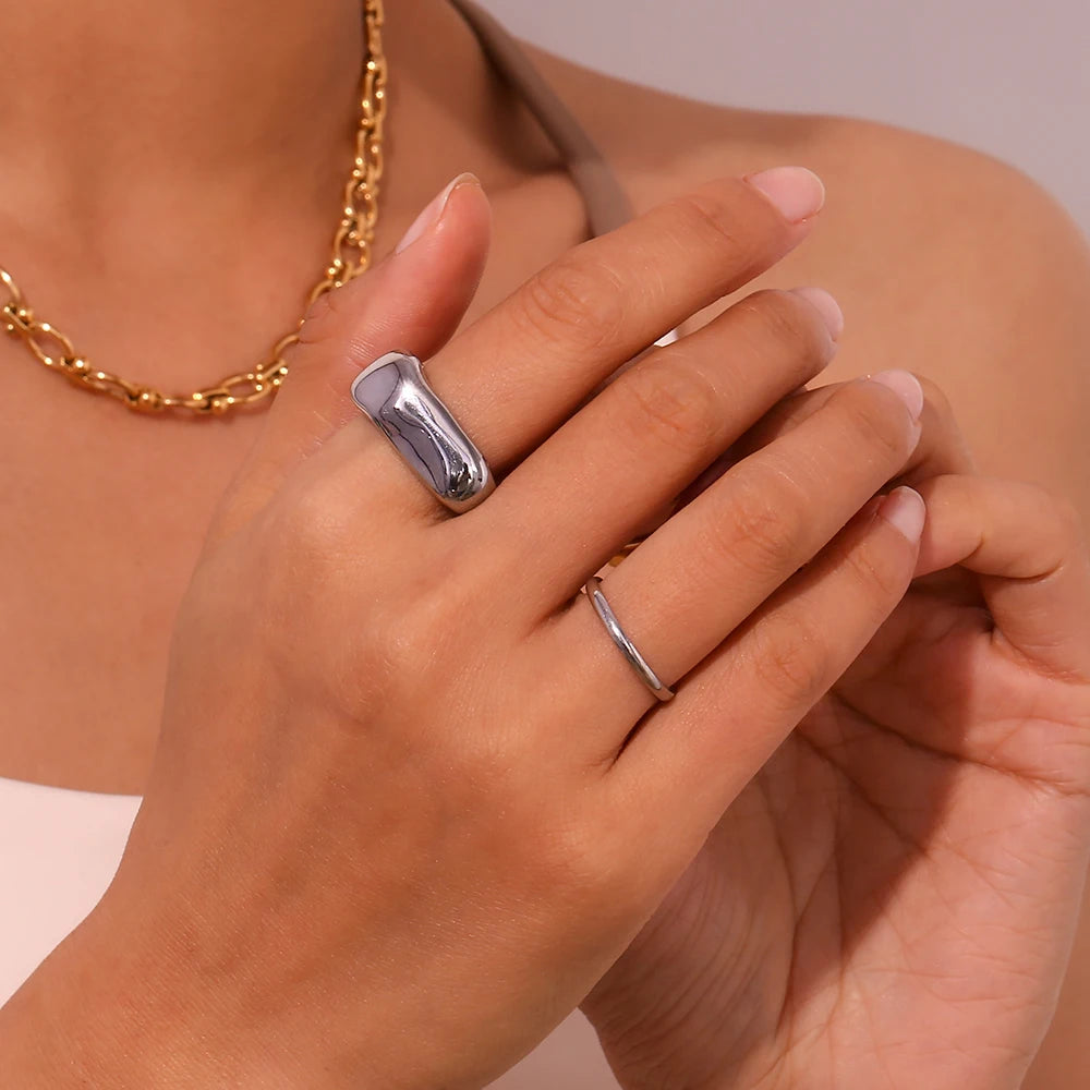 A wide, chunky dome ring in 18ct gold plated medical steel featuring a vertical ridged (fluted) texture on a high-shine polished surface.