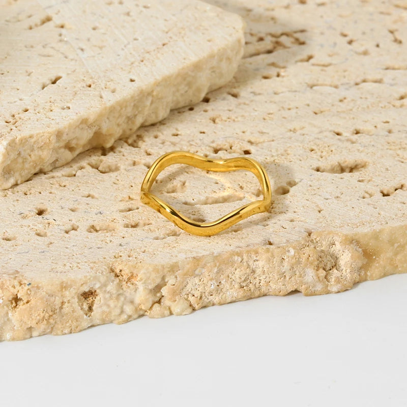 Elegant organic-shaped gold band crafted from tarnish-proof 18k gold plated steel. A versatile wavy ring perfect for a modern jewellery stack.