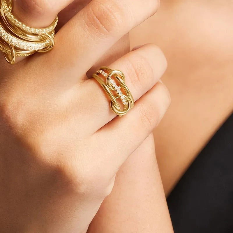 Stunning multi-layer linked ring crafted from hypoallergenic 18ct gold plated stainless steel. Polished and pave-set bands with sparkling crystals. Tarnish-proof British jewellery style.