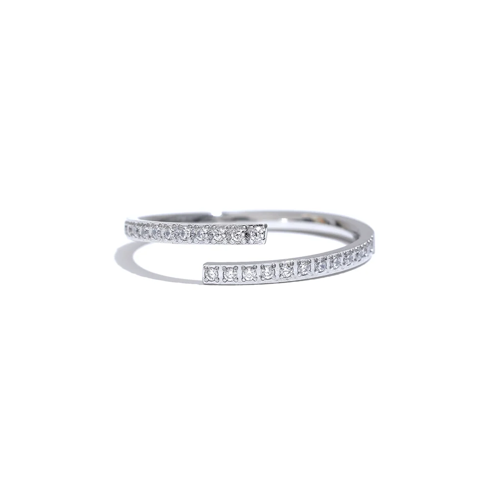 A delicate 18ct gold plated medical steel wrap ring with a bypass design, encrusted with a fine row of clear diamante crystals in a pavé setting.