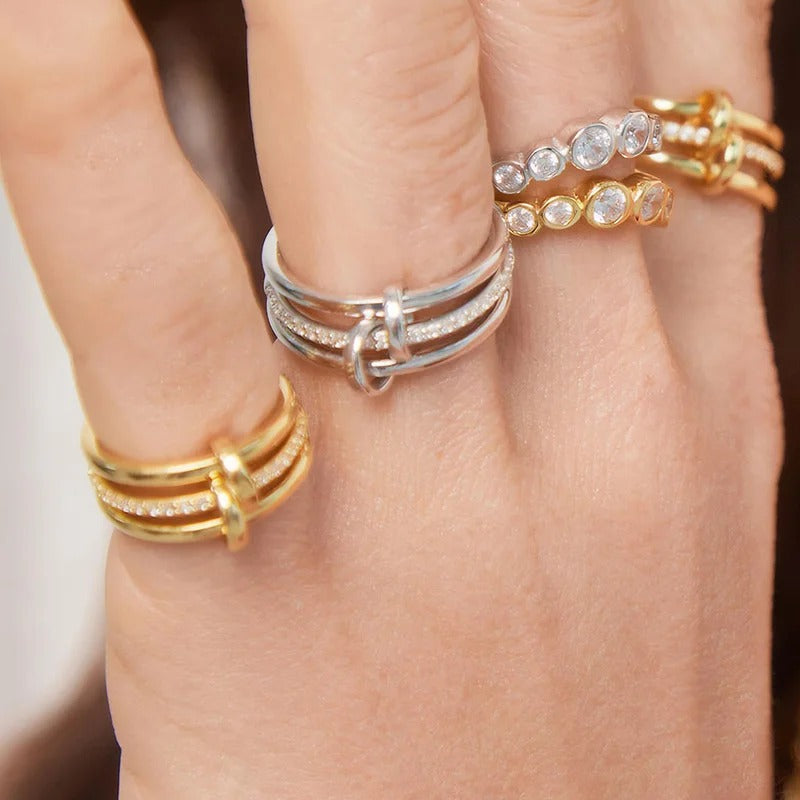 Stunning multi-layer linked ring crafted from hypoallergenic 18ct gold plated stainless steel. Polished and pave-set bands with sparkling crystals. Tarnish-proof British jewellery style.