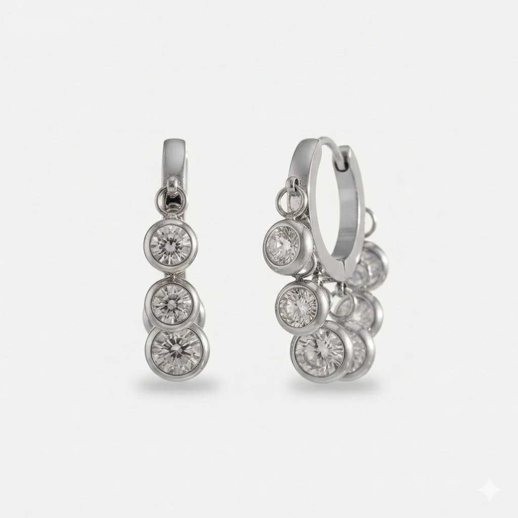 A pair of 18ct gold plated medical steel huggie hoop earrings adorned with multiple dangling round diamante crystals in polished bezel settings. Hypoallergenic and tarnish-proof jewellery.