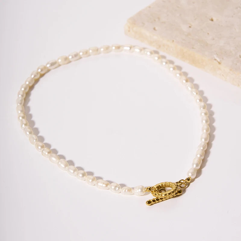 Vintage-inspired seed pearl choker with an 18k gold plated sculptural flower detail. Crafted from tarnish-proof medical-grade steel for a hypoallergenic finish. Elegant British jewellery design.