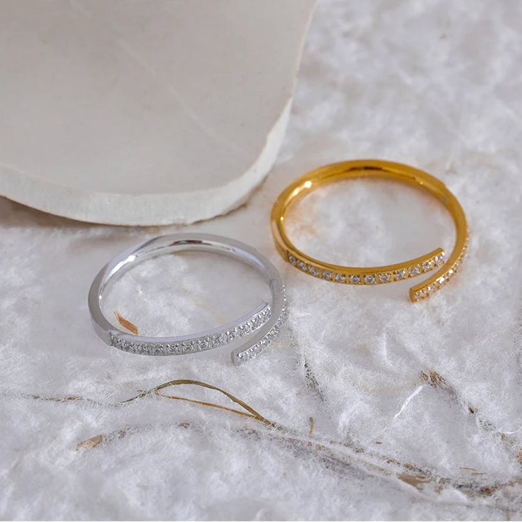Elegant slim wrap ring crafted from tarnish-proof 18k gold plated stainless steel, featuring sparkling pavé-set crystals. Perfect for a minimalist jewellery stack.